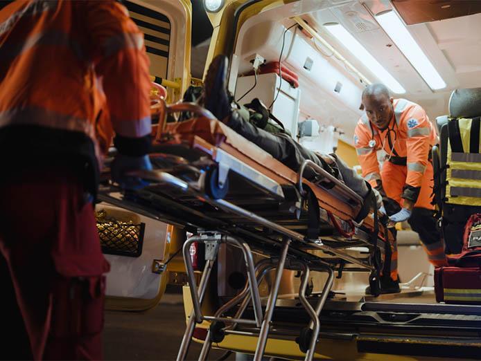 Team of Paramedics onboarding Injured Patient on an ambulance