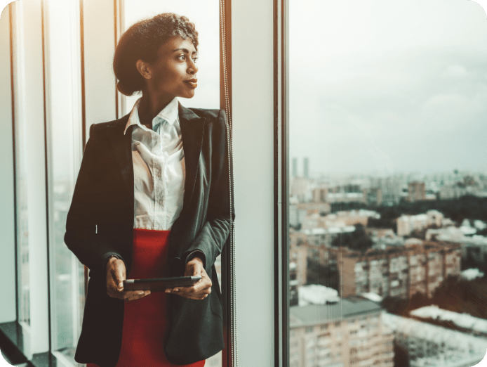 young lady staring outside at an office window