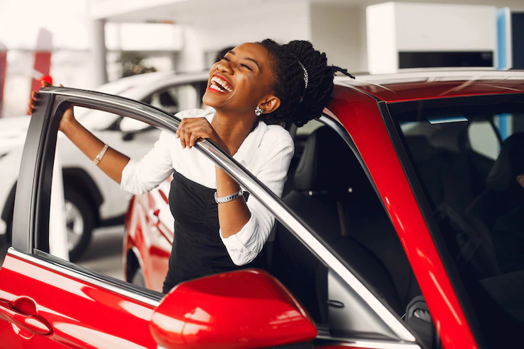 Lady all smiles holding a personal car door