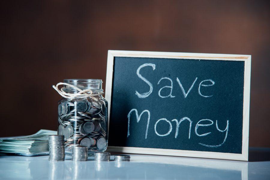 Save money writing on a small board next to a jar full of coins