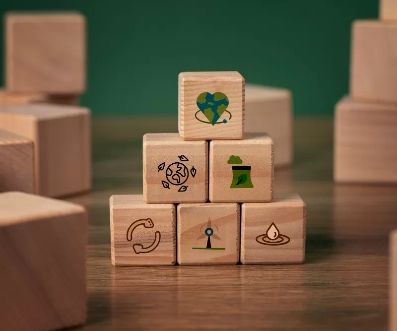 A stack of wooden cubes with images of the Sustainable Development Goals - CIC Insurance