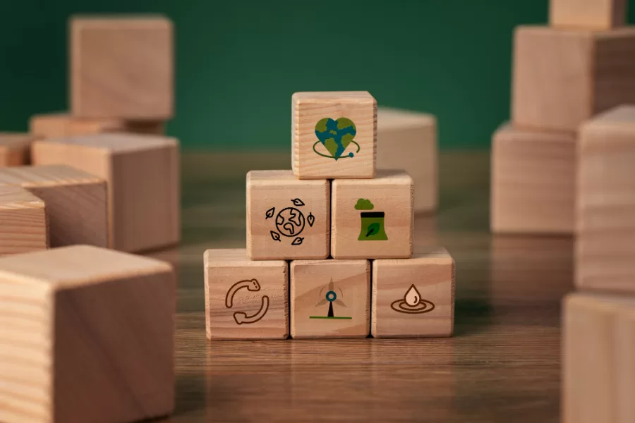 A stack of wooden cubes with images of the Sustainable Development Goals - CIC Insurance