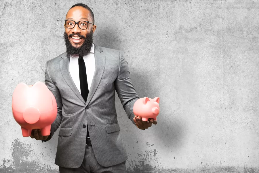 business black man saving with a piggy bank - CIC Insurance